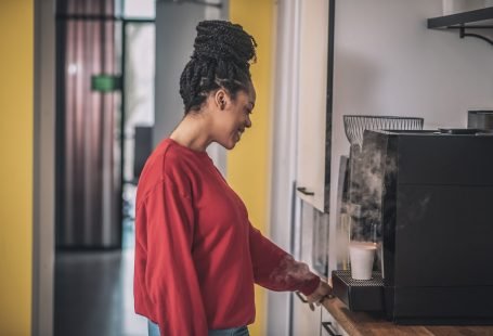 African american girl in profile near coffee machine
